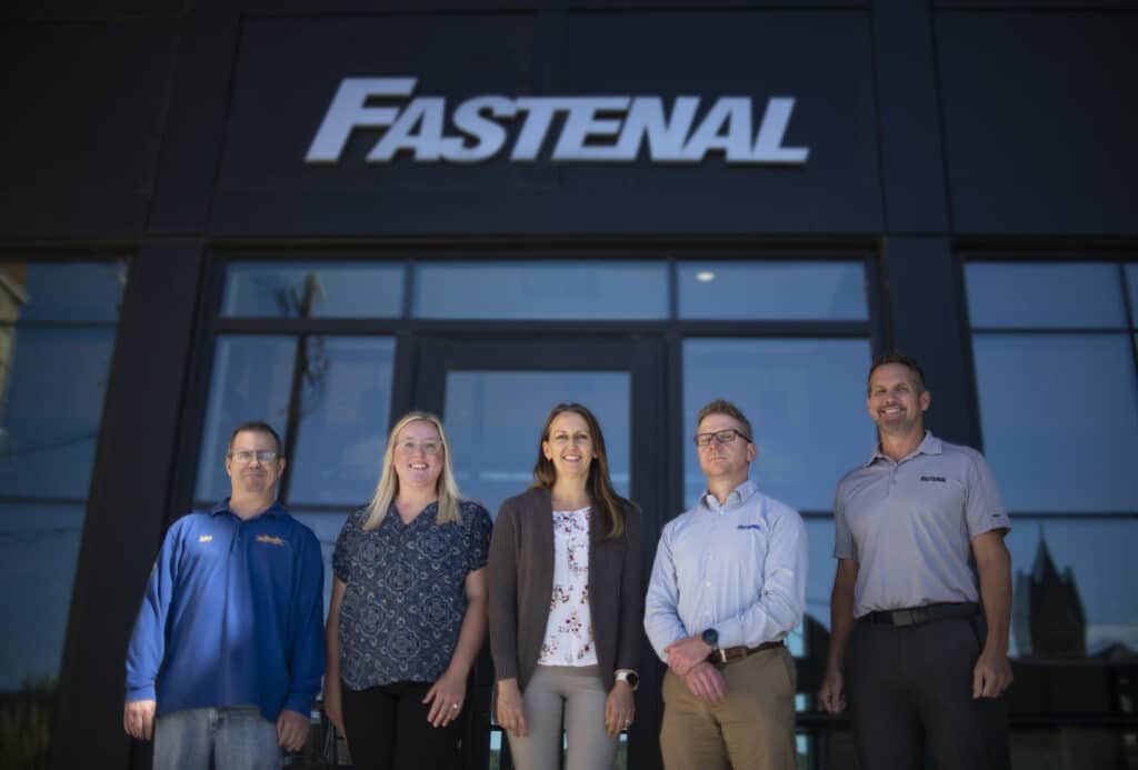 committee members standing in front of fastenal building